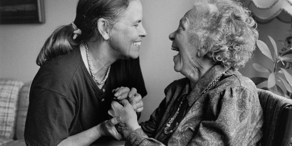 A daughter with her elderly mother who is sick with Alzheimer